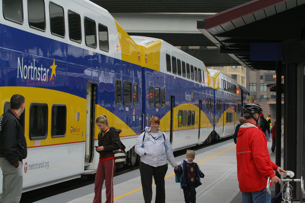 Looking east at Target Field Station, with a Northstar train at the platform and people milling about.