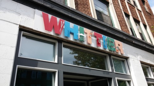sign on building that says "whittier"