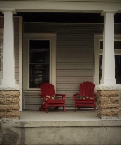 Front porch with two red chairs