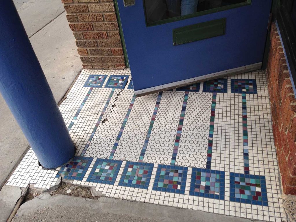 Blues and purples in mosaic squares on a white background, blue door