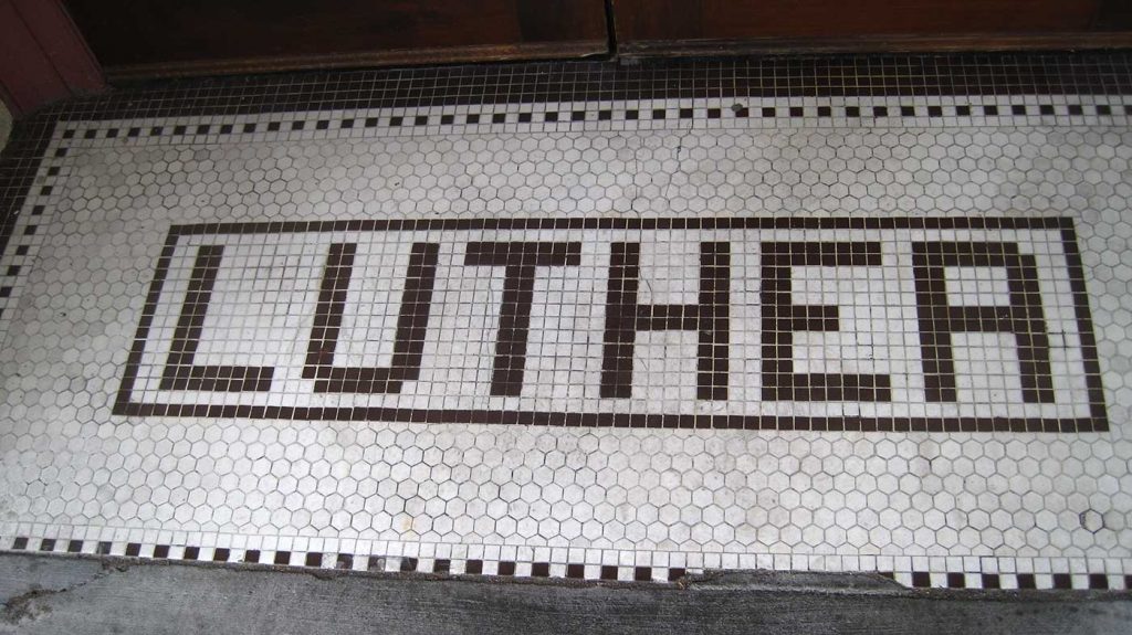 Green sans serif LUTHER tile letters on white background