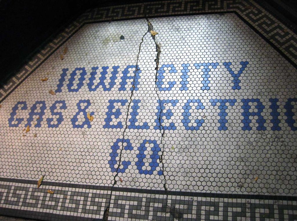 Blue tile letters, Iowa City Gas & Electric Co, white background, Greek toga-style edge