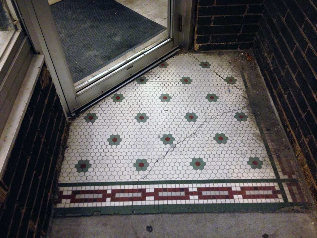 Gray-green and wine-colored flower pattern on white background, red chain border