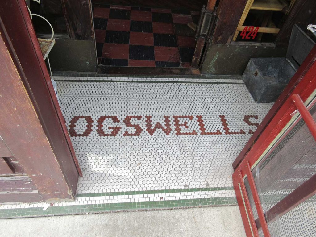 Red tile letters say Ogswells, green border, white background