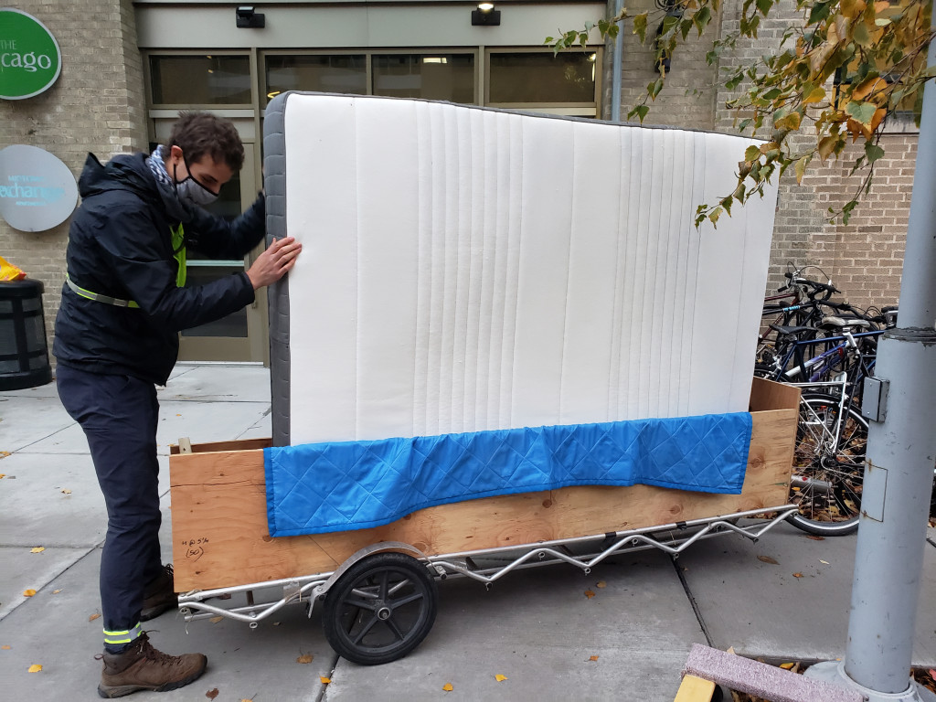 Ian stands the mattress on the long edge in the trailer. It's almost as long as the trailer!