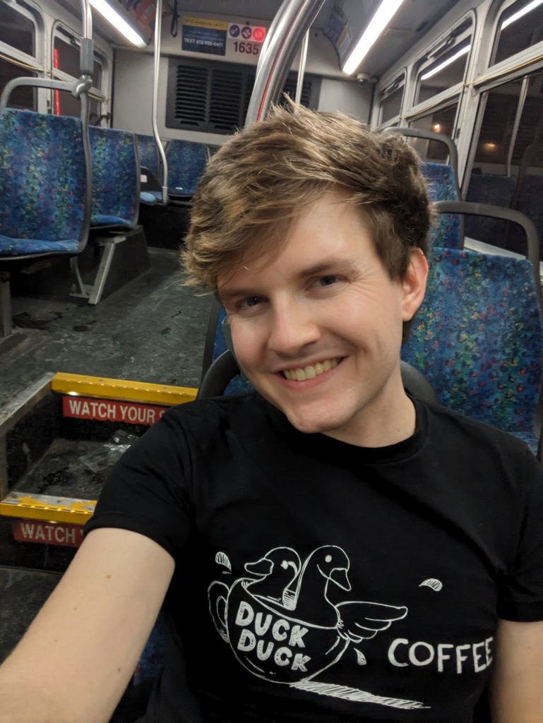 A man smiles while on a Metro Transit bus.