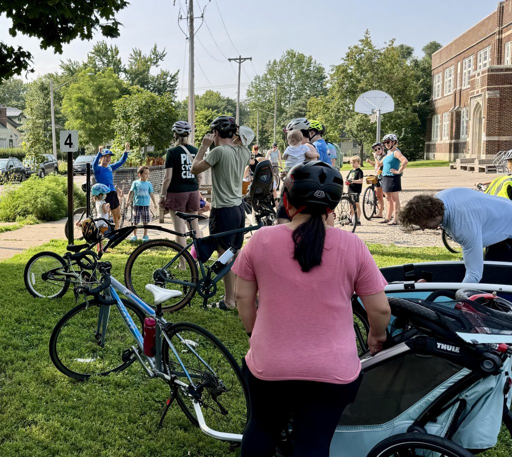Terri Lindenbaum talks to a group of cyclists before a ride. 