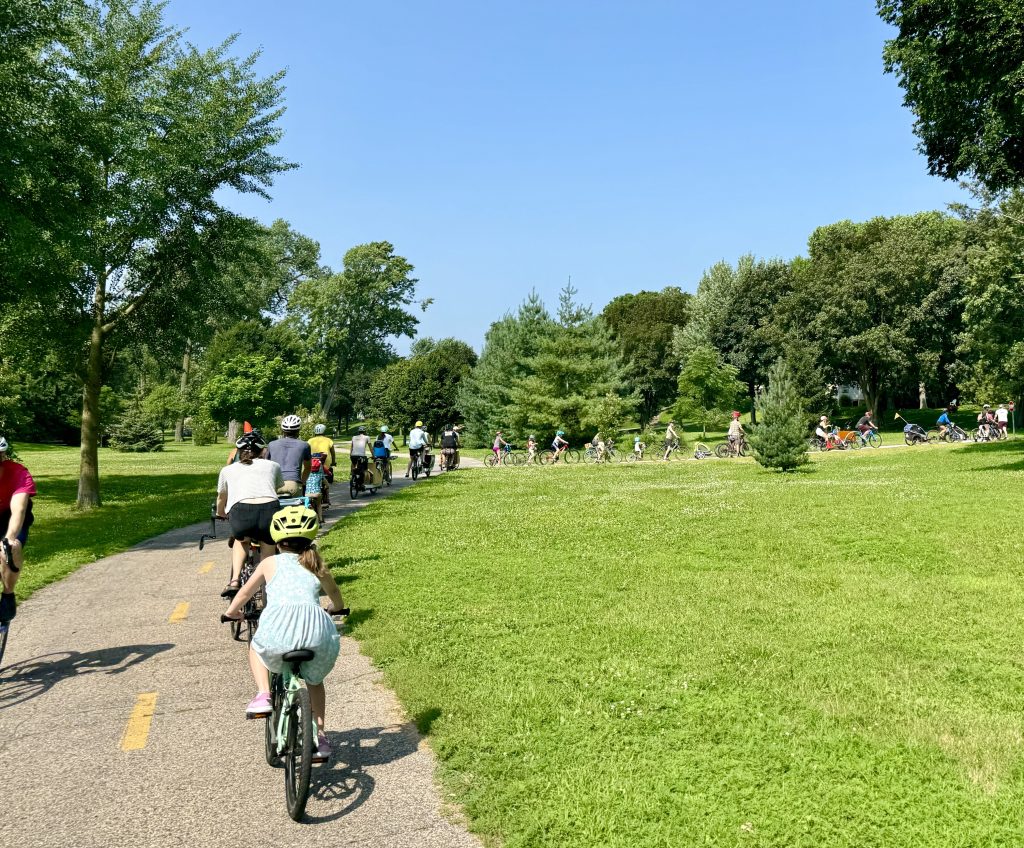 A group of cyclists along a two-lane bikeway. 