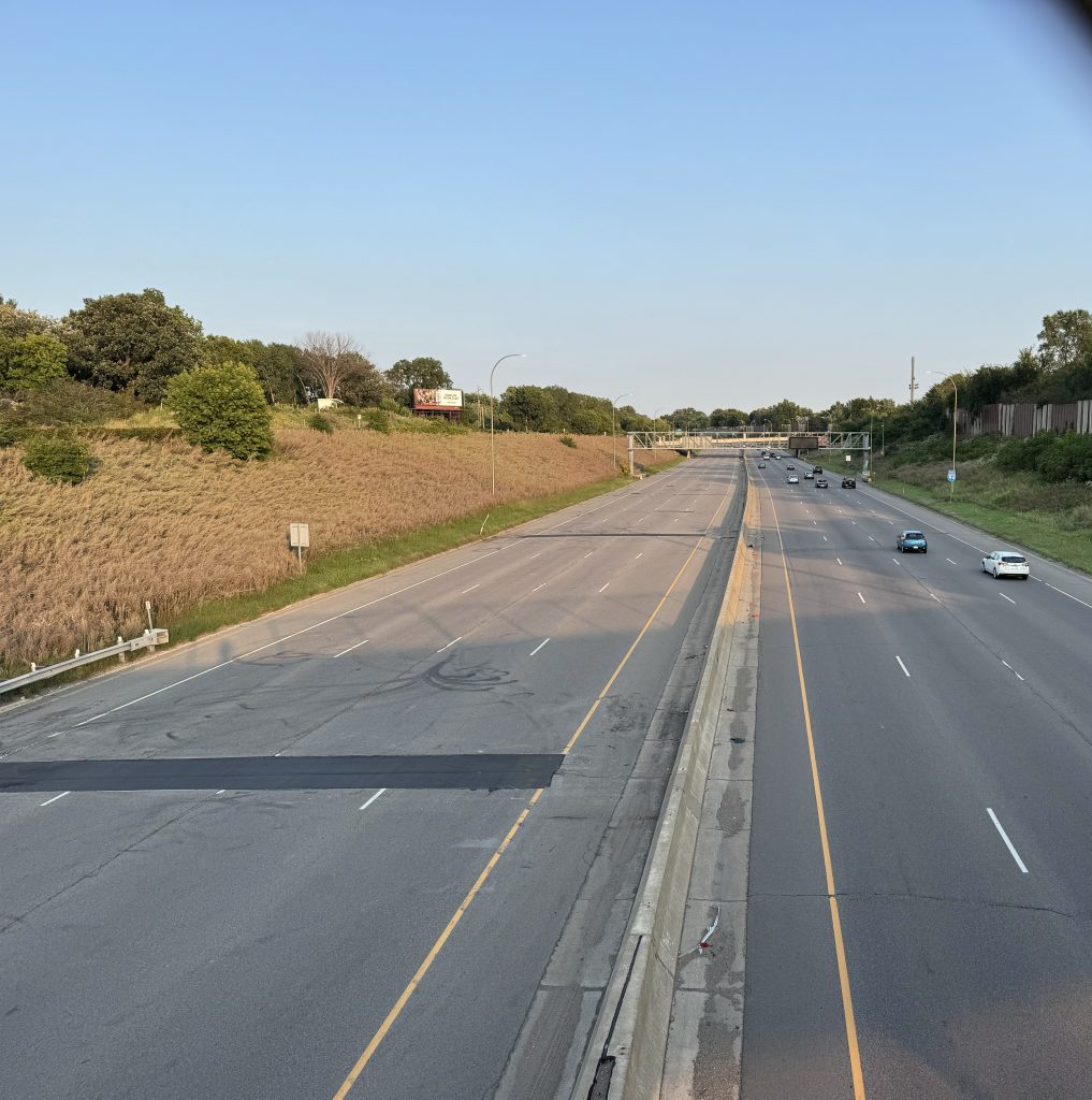 I-94 while closed  to westbound traffic. There are several cars and trucks on the right side of the highway, while the left side of the highway is empty.