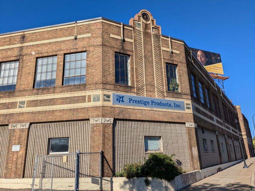 The Prestige Products building is made primarily of brown bricks.