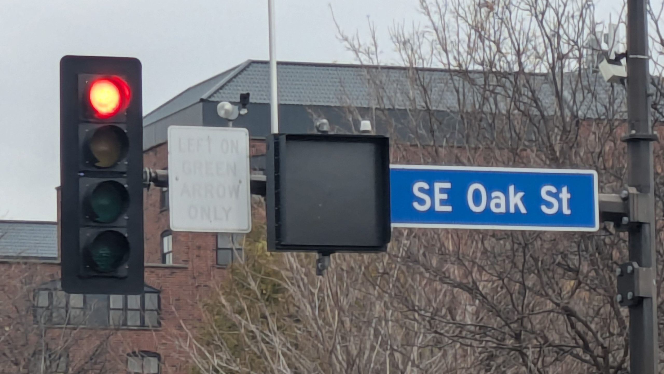 Street sign requiring left turns on green arrow only,