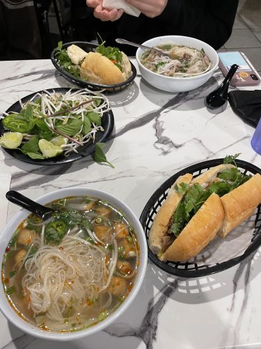 Steak Bahn Mi and Pho shown atop a table at IPho by Saigon.