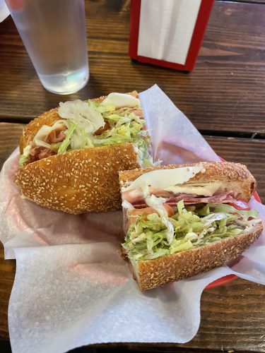 Italian Combo sandwich shown in a plastic tray at a table in Mario's.