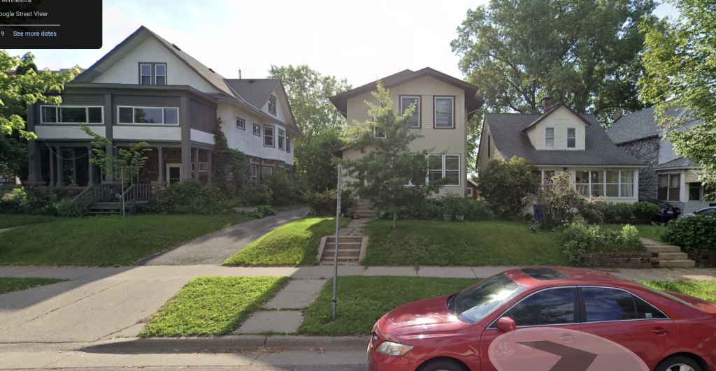 Three houses of varying architectural styles sit on a tree-lined residential street. The house on the left is a large, modernized Craftsman-style home with dark trim, large windows, and a covered front porch. The middle house is a contemporary two-story structure with a beige exterior and a simple, boxy design. The house on the right is a traditional early 20th-century home with a steep gable roof, dormer windows, and an enclosed front porch. The sidewalk and steps leading to each home are lined with greenery.