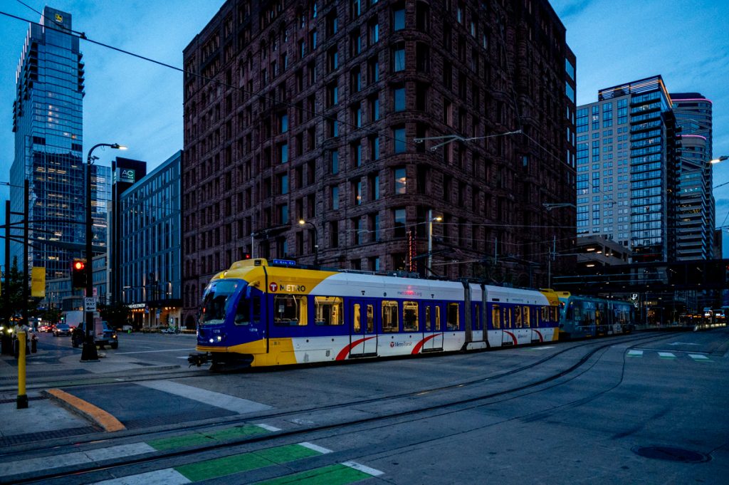 A train passing the Lumber Exchange building in downtown Minneapolis.