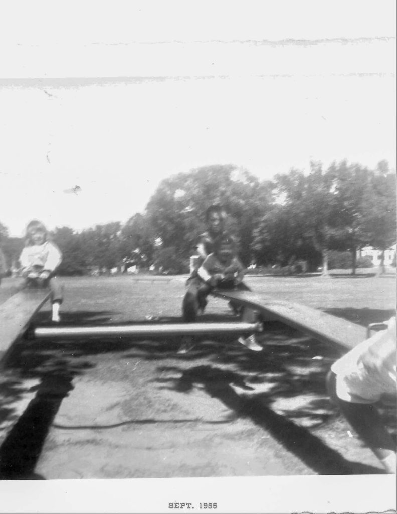 Joan and older brother Jerry, on the seesaw