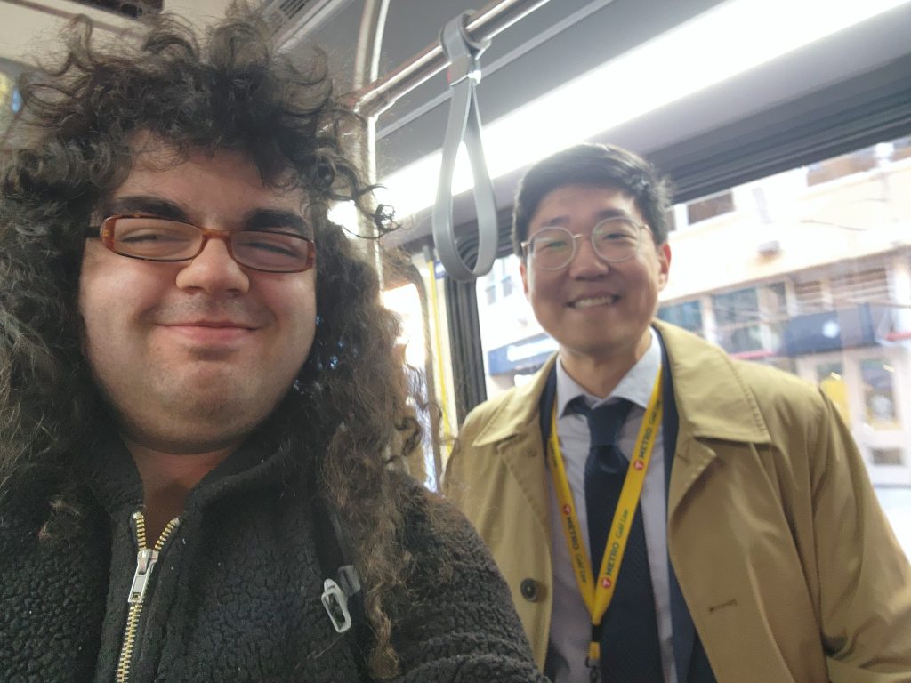 Two people pose for a selfie on the metro.