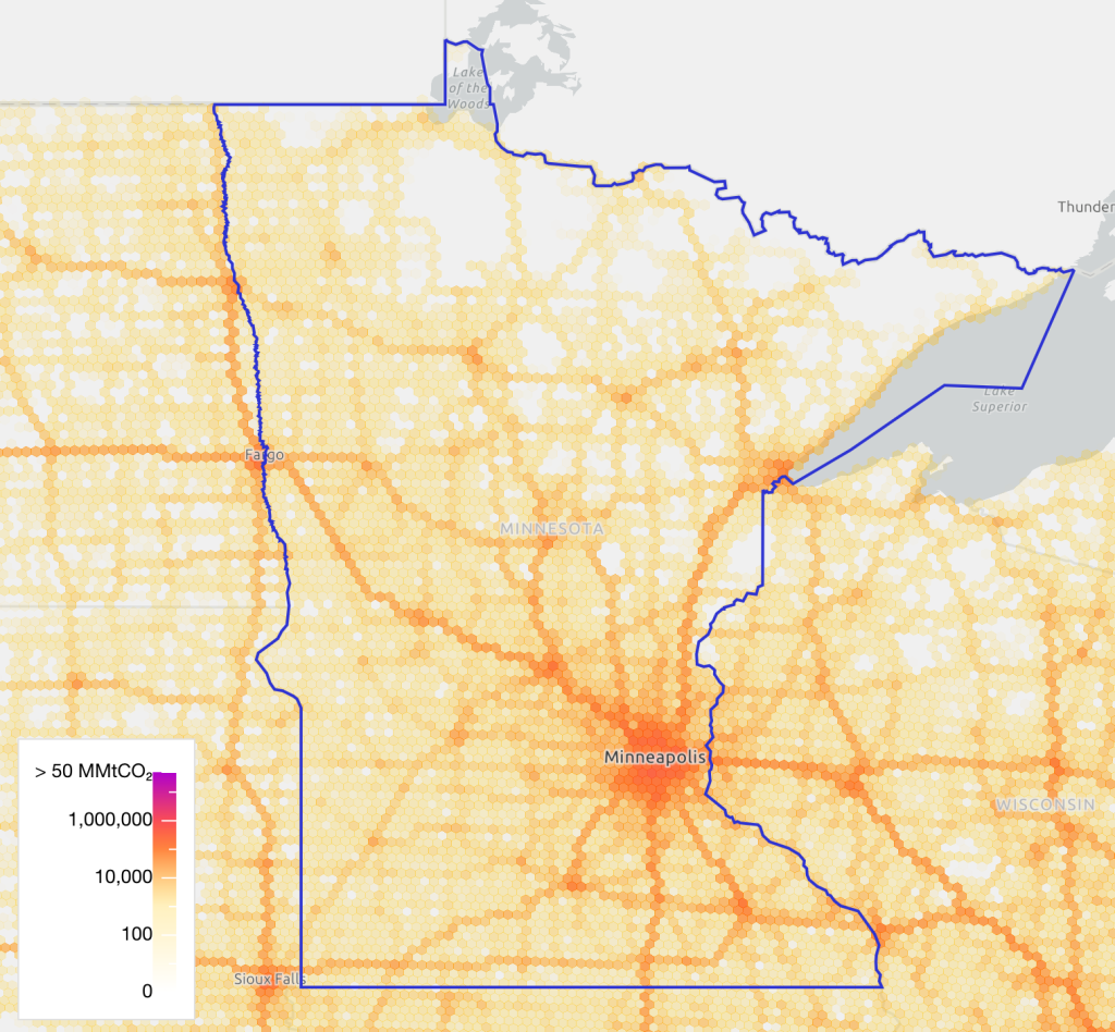 Hexagonal heat map of Minnesota showing CO₂ emissions from all sources, with color intensity ranging from light yellow (low) to deep red (high). The Minneapolis–Saint Paul metro area shows the highest emissions, and major highways across the state are clearly visible as orange and red lines, indicating significant emissions along those routes.