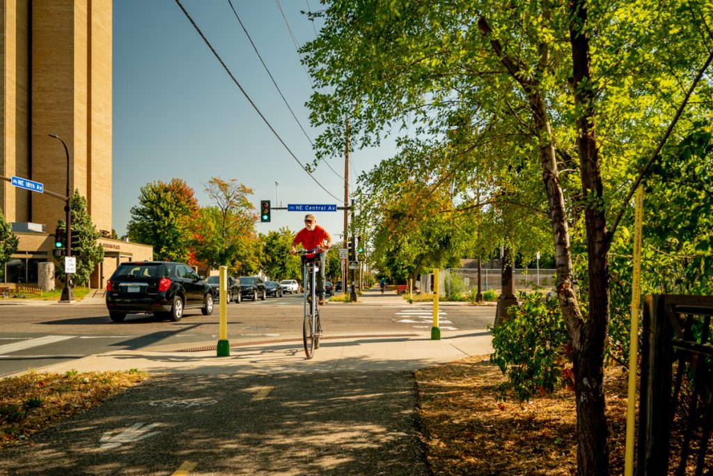 A cyclist on a high wheel bike rides on a paved bike trail in Northeast Minneapolis. 