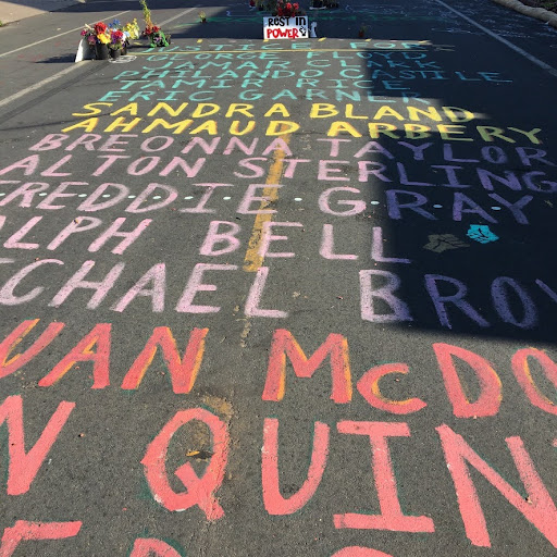 Mari Hernandez's mural with the names of people killed by police covers Chicago Avenue, north of 38th Street. 