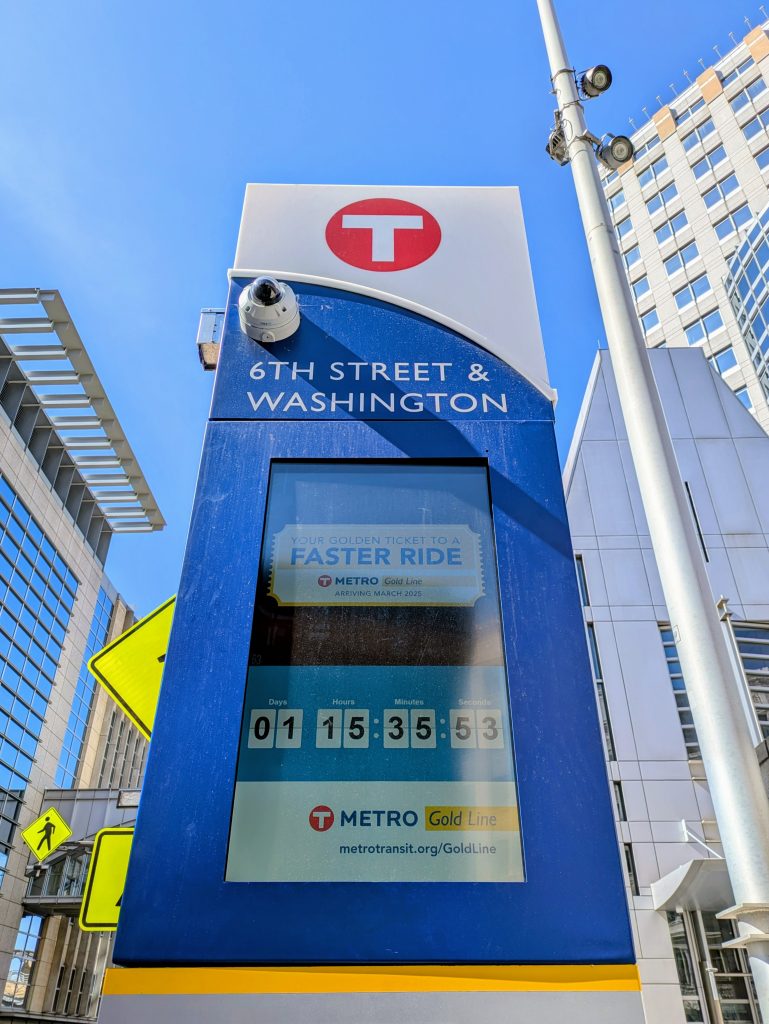 A Nextrip display at 6th Street & Washington includes a countdown timer to the Gold Line launch