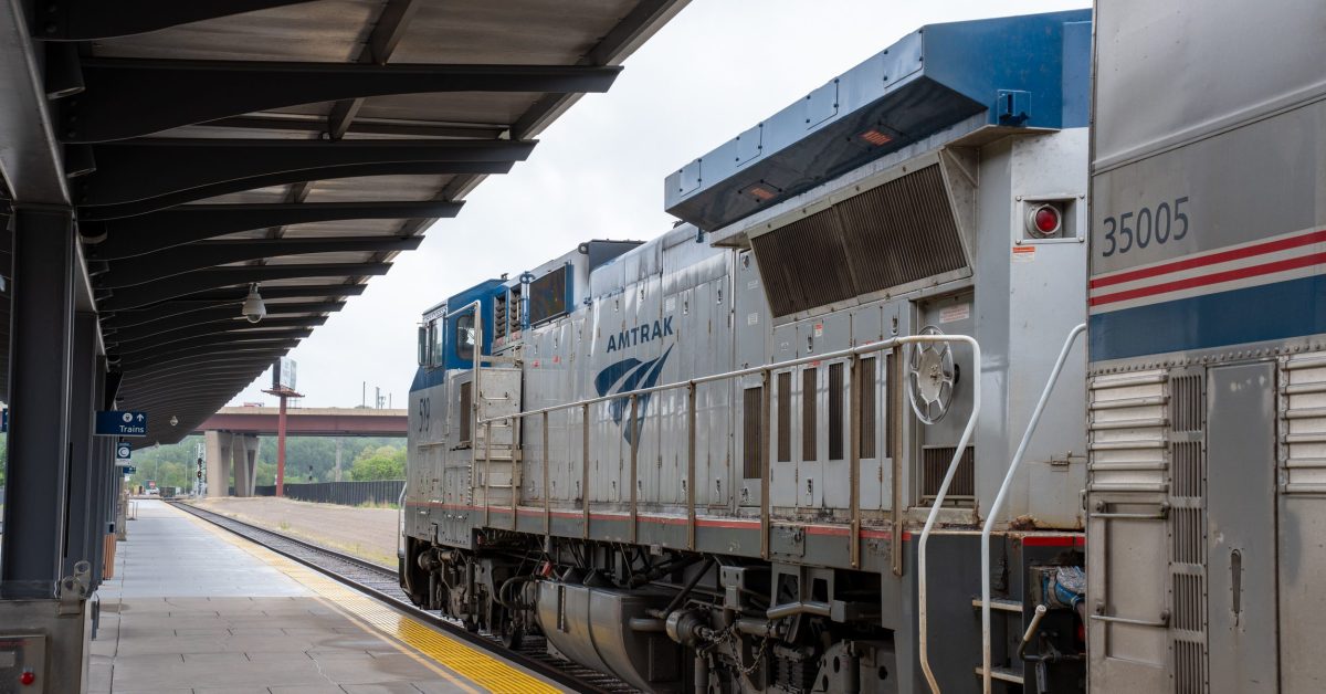An Amtrak locomotive sitting at a train station.