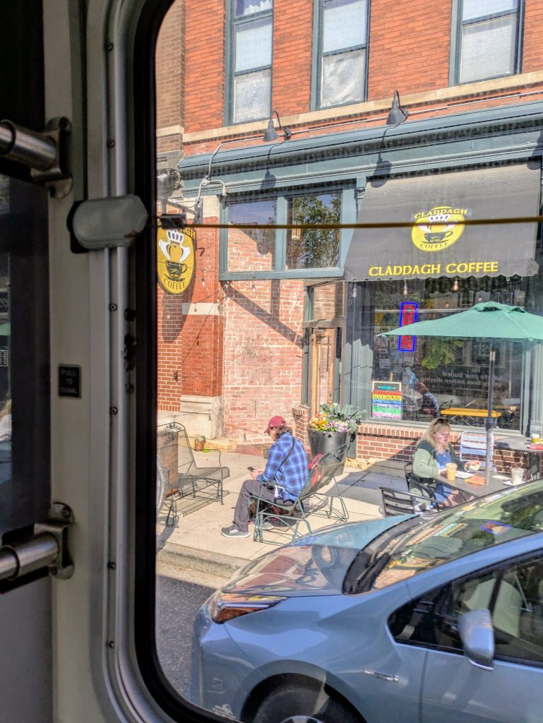 A view of Claddagh Coffee on West Seventh Street through a route 74 bus window
