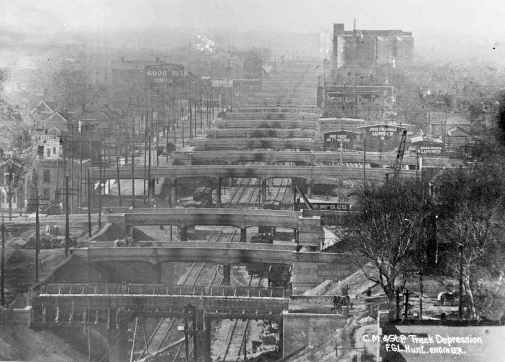 View from over Park Ave looking west showing 20+ bridges in a line with visible soot strains over the tracks.