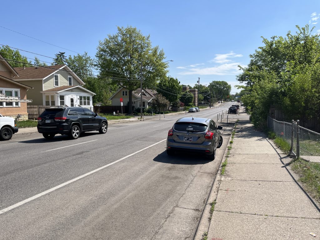 Several cars flow down a street in south Minneapolis.