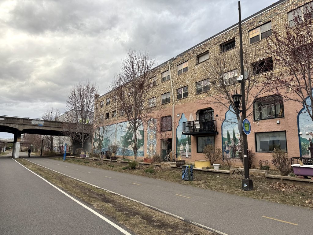 Former industrial building between Grand and Pleasant avenues turned into housing with two-story arches visible but largely filled-in.