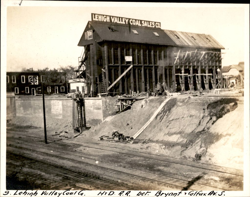 Lehigh Valley Coal Sales Company multi-story building above a retaining wall and what appears to be the start of construction in the trench and sloped edge.