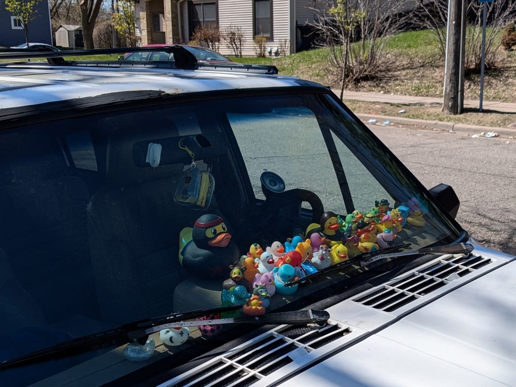 a vehicle with plastic ducks visible through the windshield