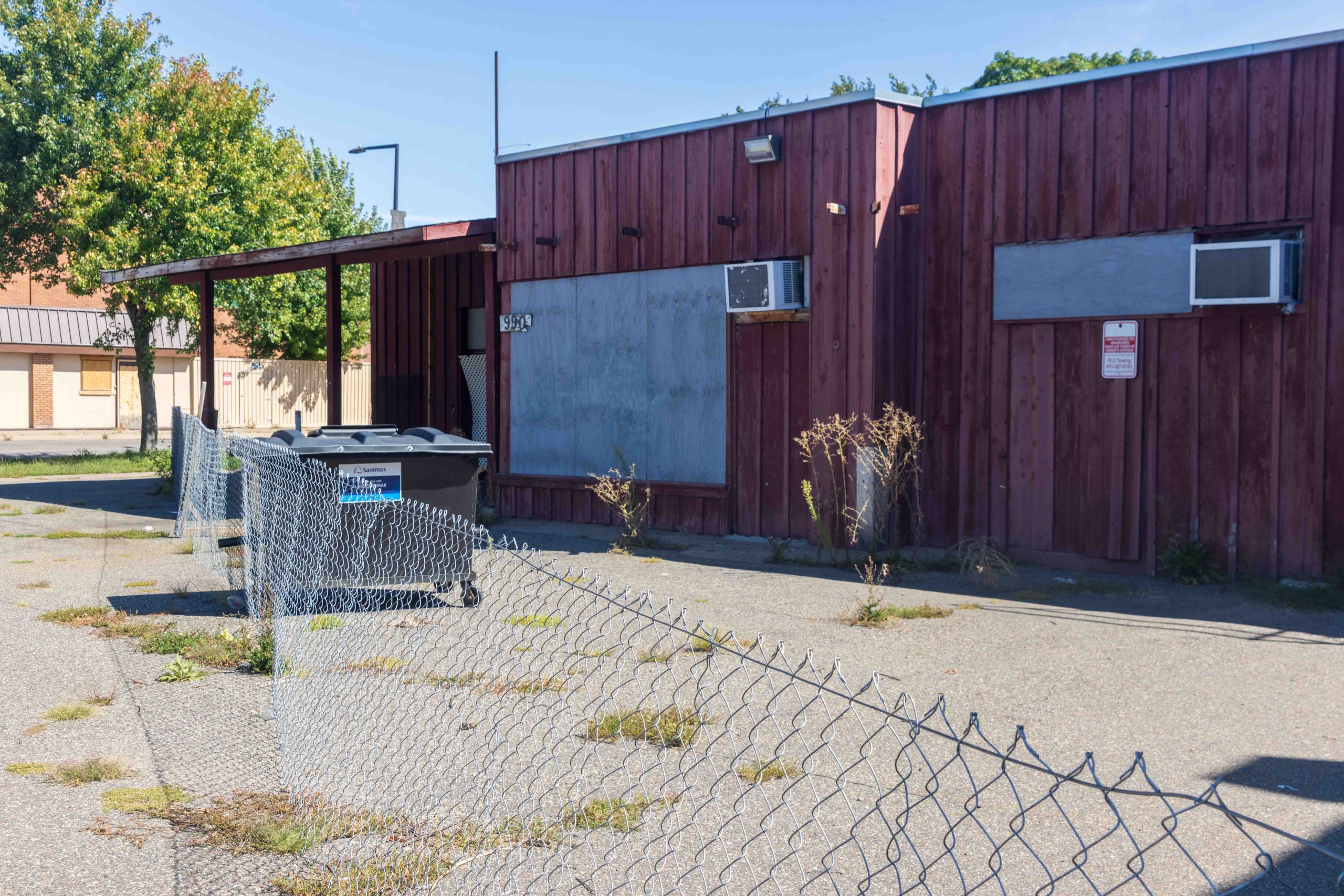 The former 52 Market and Trading, just south across Jenks from Checkerboard, was also heavily damaged by a suspicious fire on August 9, 2023 remains fenced off.