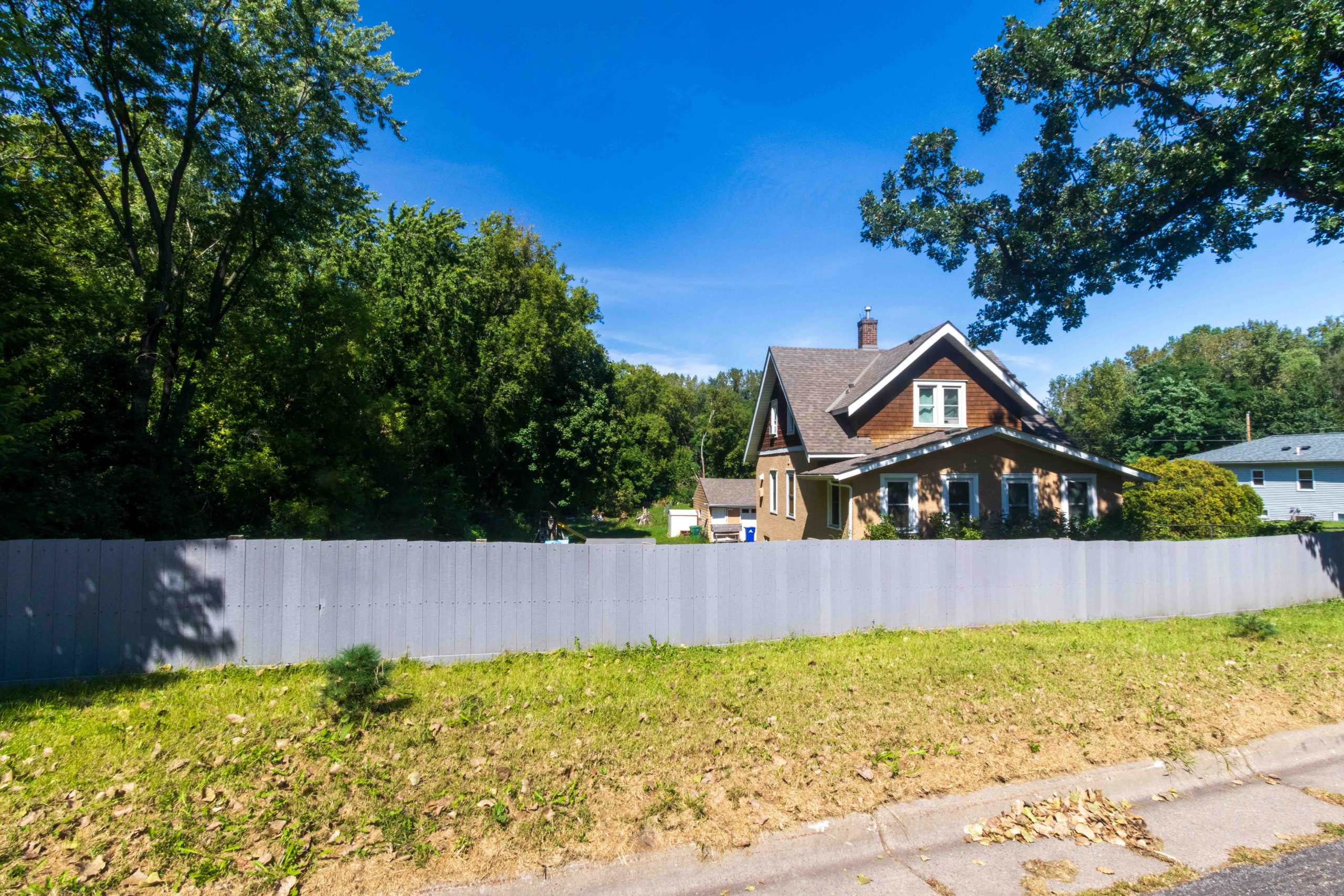 Home almost hidden by fence because of lot slope at 1455 Ames.