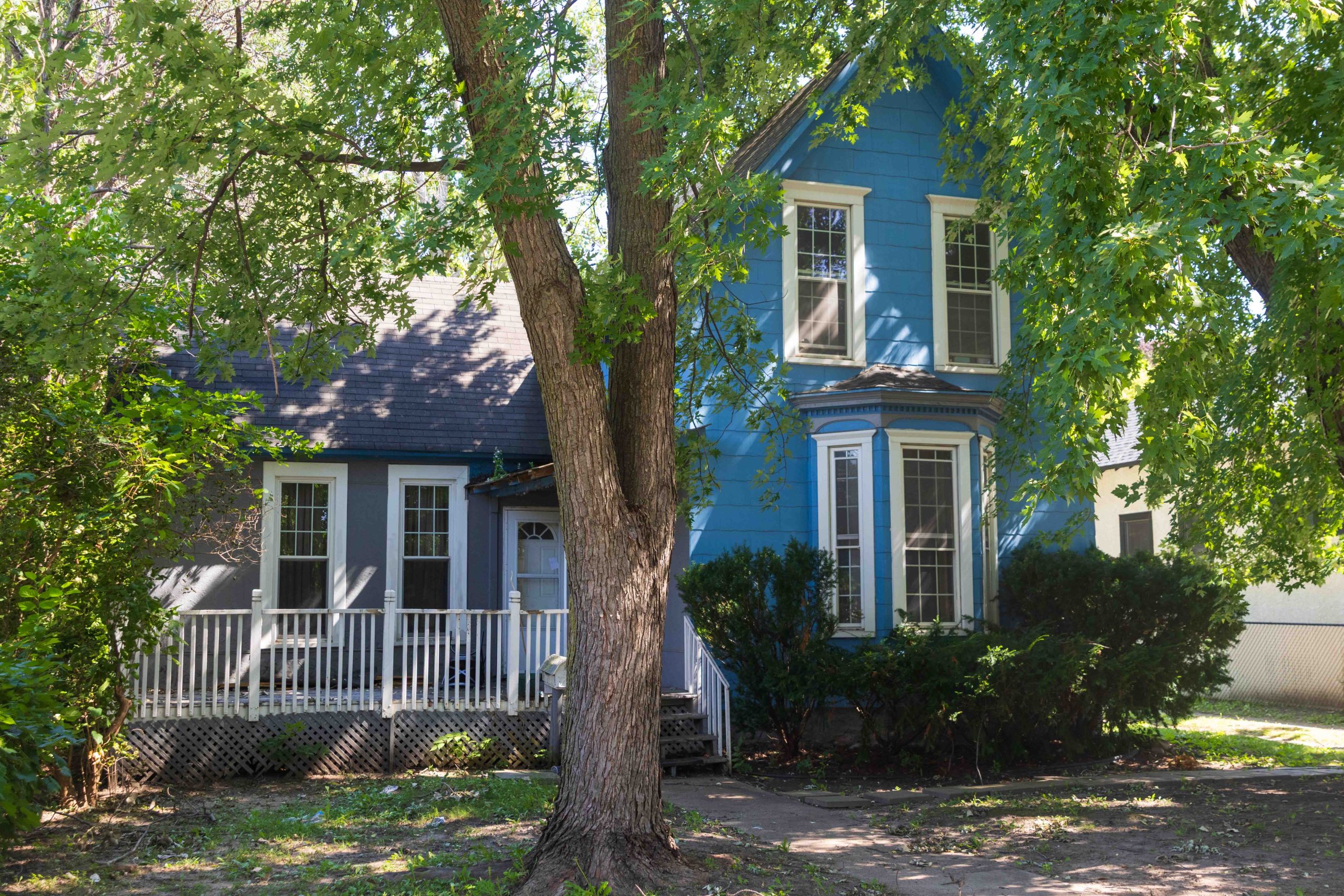 Trees and bushes nearly hide 886 Johnson Parkway. The well-kept exterior belies that the home dates back about a century and one-half.