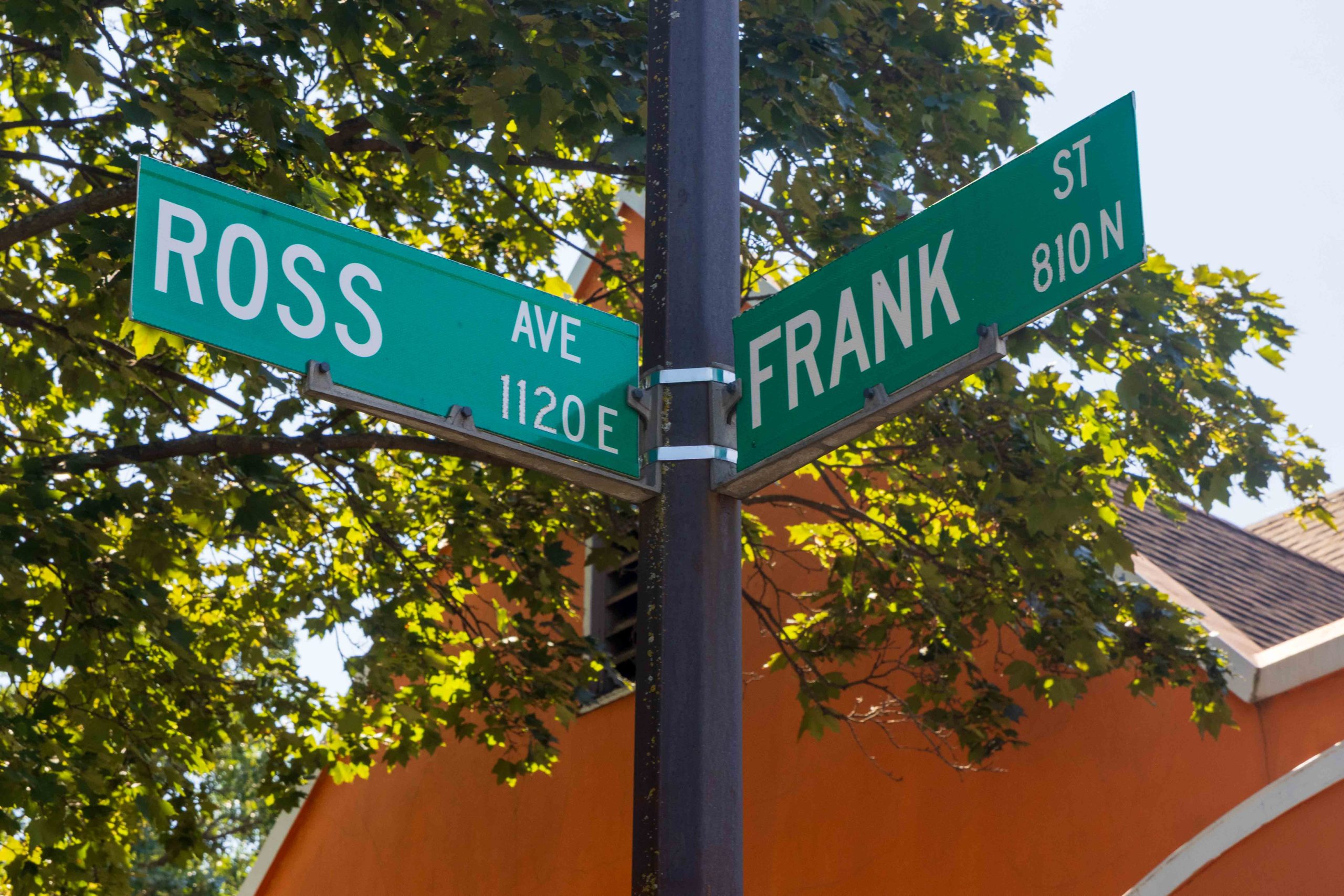 Street signs on light pole of intersection of Frank and Ross.