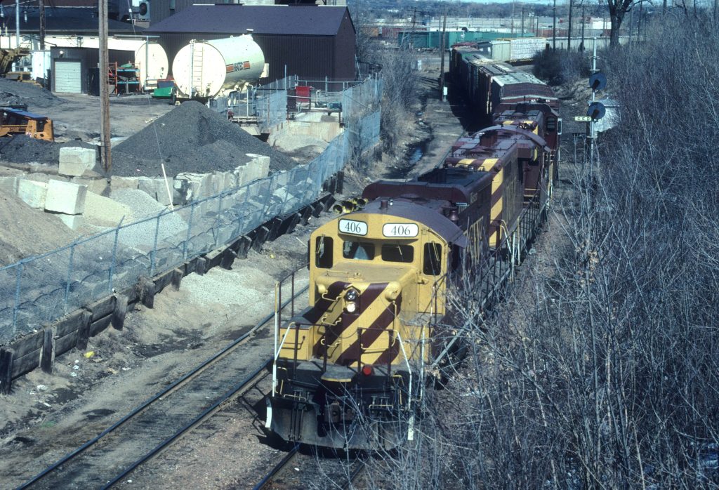 Freight train passing under the Cedar Avenue bridge.