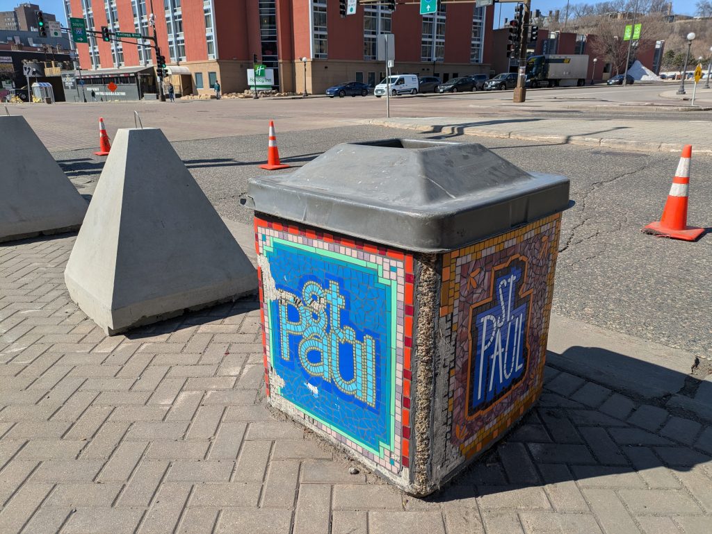 A garbage can sporting “St. Paul” in mosaic