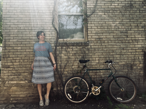 A woman next to her bike learning to be herself.