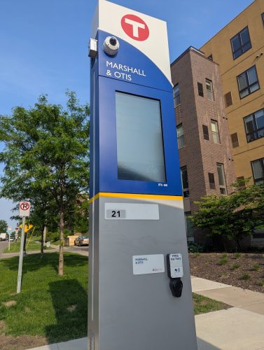An arrival-display kiosk, with a button that reads "Press for times."