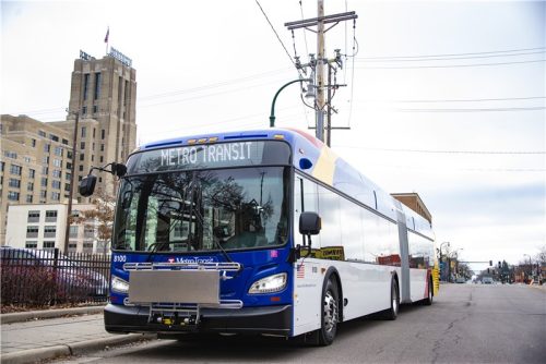 A BRT bus with the Art Deco Midtown Global Market building in the background.