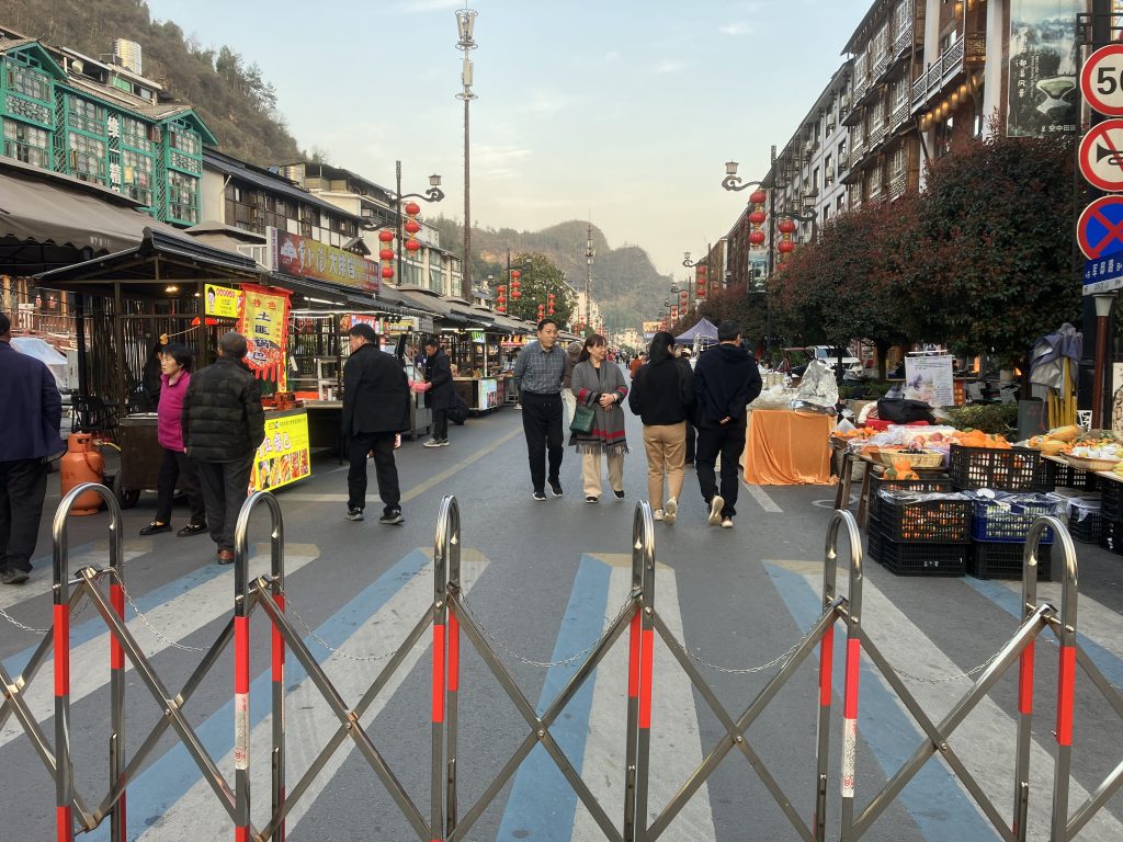 A street with a pedestrian market closed off via a gate