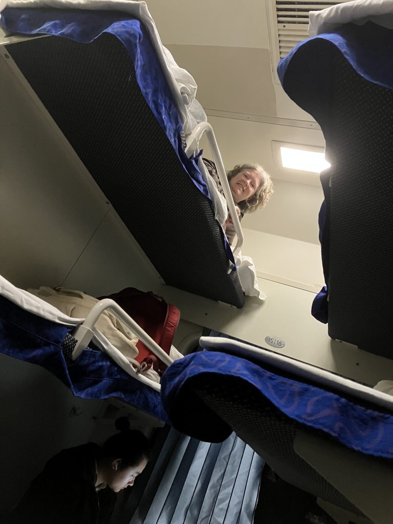 A sleeping cabin with two sets of three beds, stacked vertically