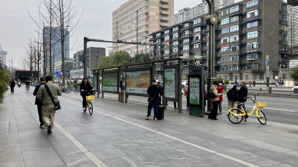 A wide bike path and a bus stop
