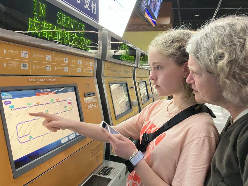 Author's daughter expertly using a ticket machine