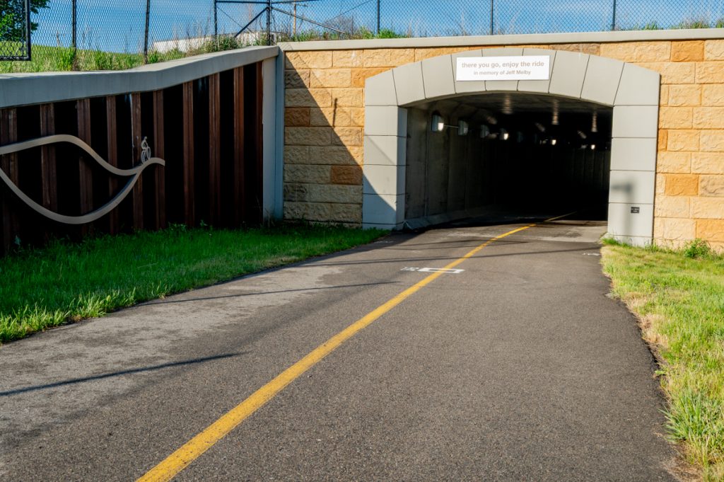 A paved trail leads to an underpass