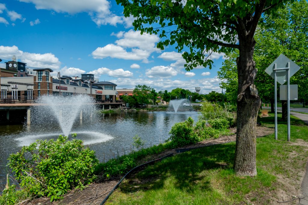 A fountain and strip mall surrounded by greenery at SouthWest Station