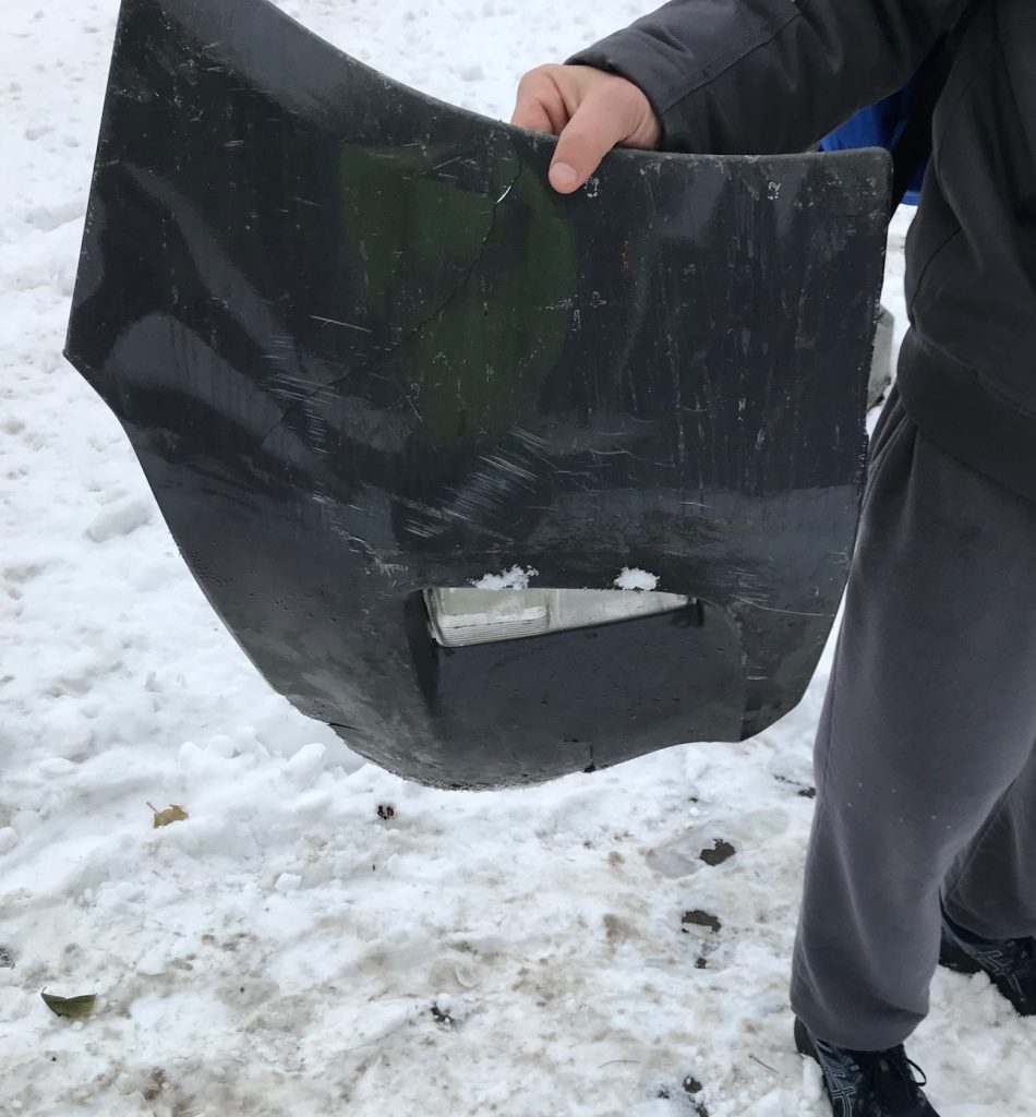 Person holding a fragment of a vehicle