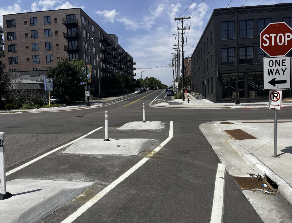 Separated bike lake with concrete dividers heading into an intersection