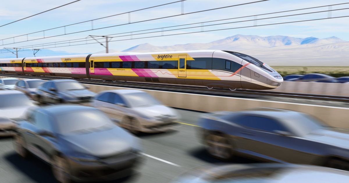 A high-speed Brightline West train travels on an elevated track through a desert landscape, passing alongside a busy highway filled with blurred cars to emphasize speed. The sleek, modern train features a colorful yellow, pink, and orange design.